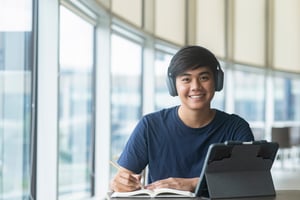 young-collage-student-using-computer-mobile-device-studying-online